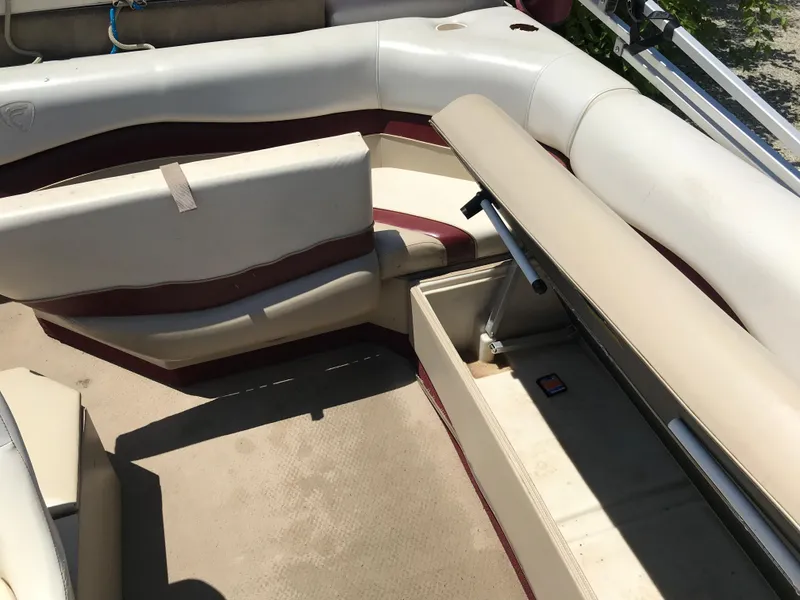 Slide: The Image of 2000 Fisher Freedom 241 DLX boat interior with open storage compartment and cushioned seating. - 11