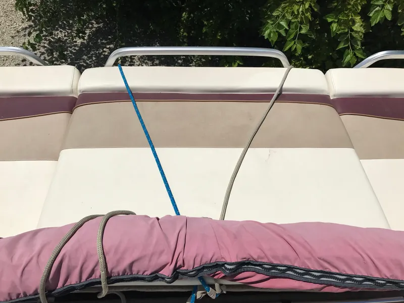 Slide: The Image of Rear view of a 2000 Fisher Freedom 241 DLX boat with cushioned seating. - 13