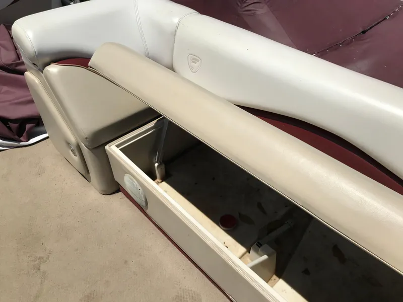 Slide: The Image of 2000 Fisher Freedom 241 DLX boat seat with storage compartment open. - 14