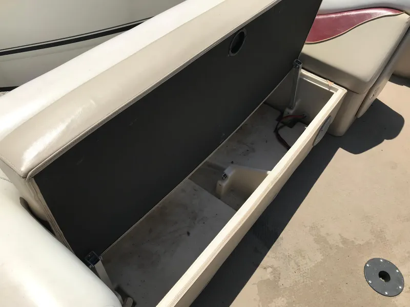 Slide: The Image of Open storage compartment on a 2000 Fisher Freedom 241 DLX boat seat. - 15