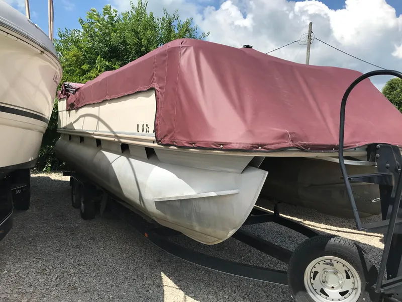 Slide: The Image of 2000 Fisher Freedom 241 DLX pontoon boat with maroon cover on trailer. - 16