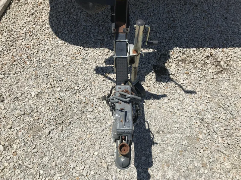 Slide: The Image of Trailer hitch of a 2000 Fisher Freedom 241 DLX on gravel surface. - 6