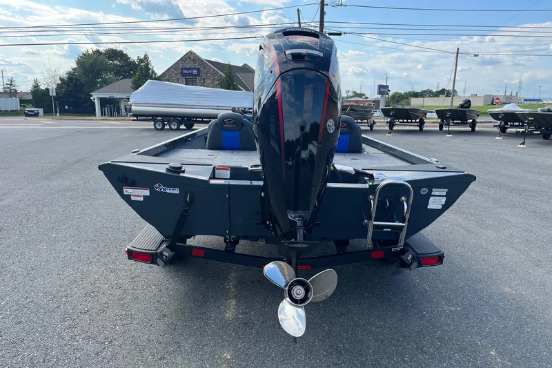 Slide: The Image of 2026 Ranger RT188 boat with Mercury outboard motor, parked in a lot. - 2