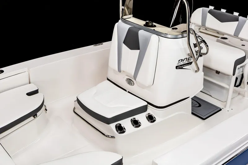 Slide: The Image of Manufacturer Provided Image: 2023 Robalo 206 Cayman boat interior with open storage compartments and control console. - 11