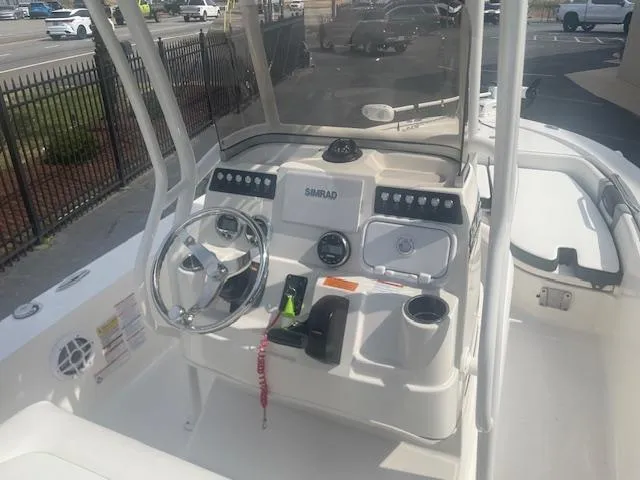 Slide: The Image of 2023 Robalo 206 Cayman boat on trailer, featuring Yamaha engine, under clear blue sky. - 4