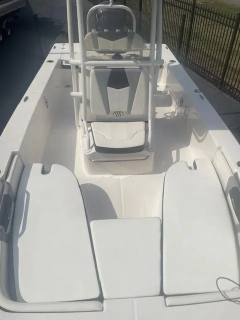 Slide: The Image of 2023 Robalo 206 Cayman boat interior with cushioned seating and trolling motor. - 6