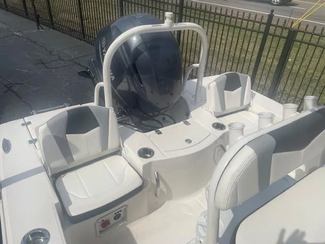 Slide: The Image of 2023 Robalo 206 Cayman boat with outboard motor and seating area. - 8