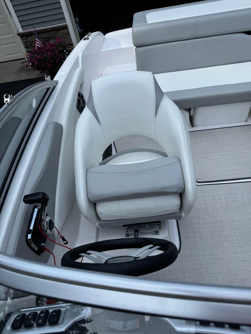 Slide: The Image of 2021 Regal 1900 ES boat interior with white and gray seating and steering wheel. - 10