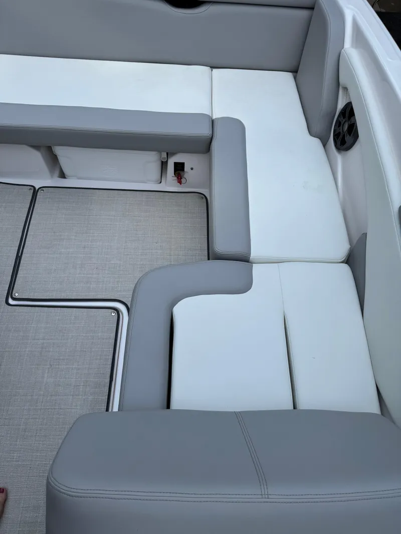 Slide: The Image of 2021 Regal 1900 ES boat interior with gray and white cushioned seating. - 12