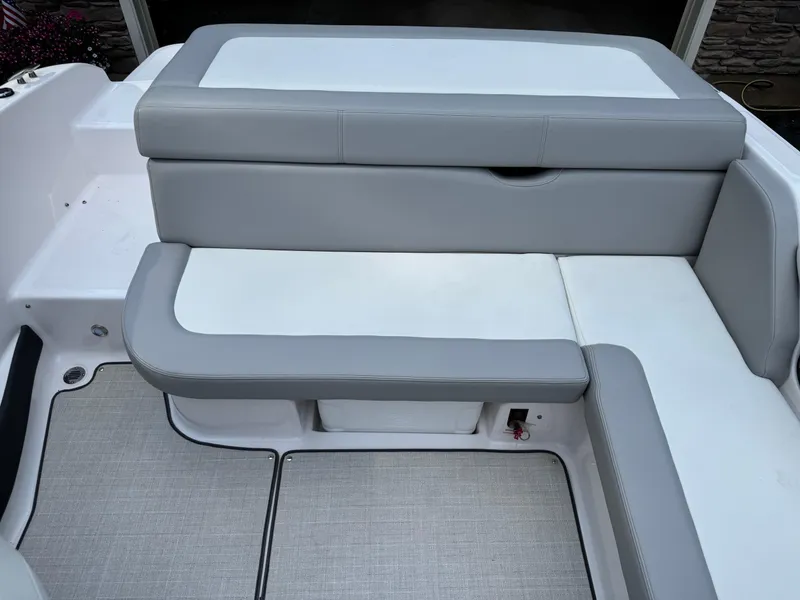 Slide: The Image of 2021 Regal 1900 ES boat interior seating with gray and white upholstery. - 13