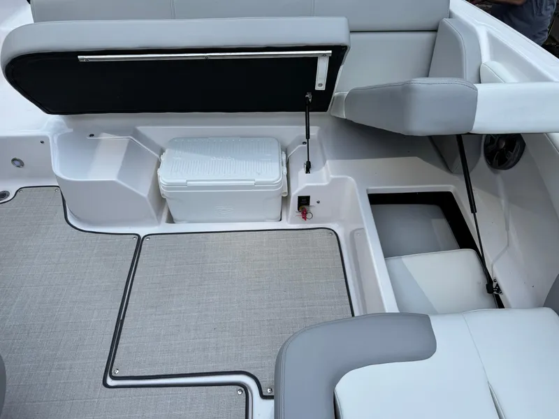 Slide: The Image of Interior of a 2021 Regal 1900 ES boat featuring seating and storage compartments. - 14