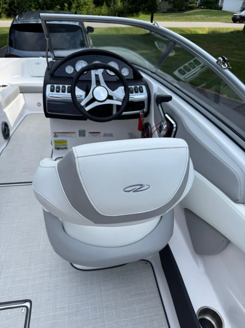 Slide: The Image of 2021 Regal 1900 ES boat interior with steering wheel and captain's seat. - 15