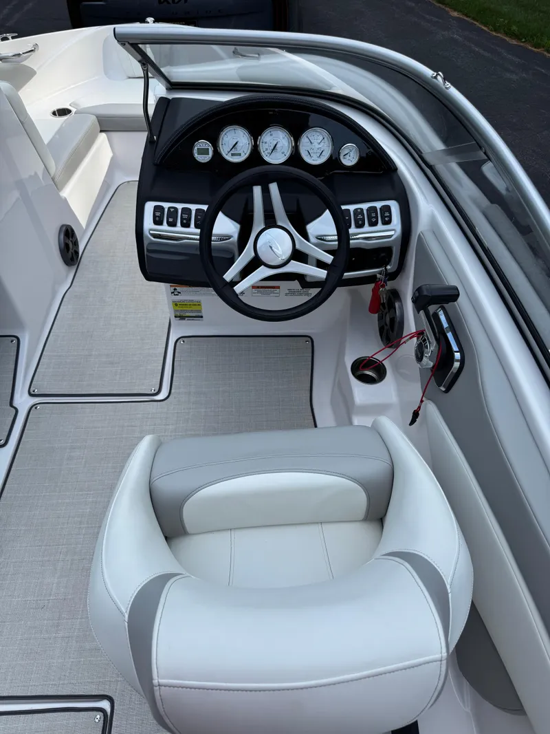 Slide: The Image of 2021 Regal 1900 ES boat interior with steering wheel and dashboard controls. - 16