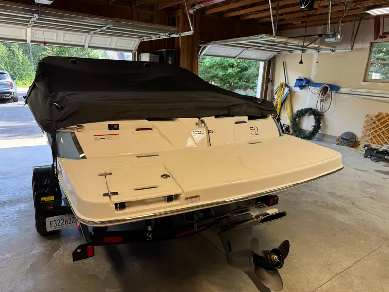 Slide: The Image of 2021 Regal 1900 ES boat in garage, covered, with visible propeller and trailer. - 3