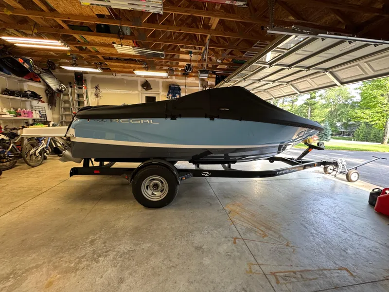 Slide: The Image of 2021 Regal 1900 ES boat with cover on trailer in garage. - 5