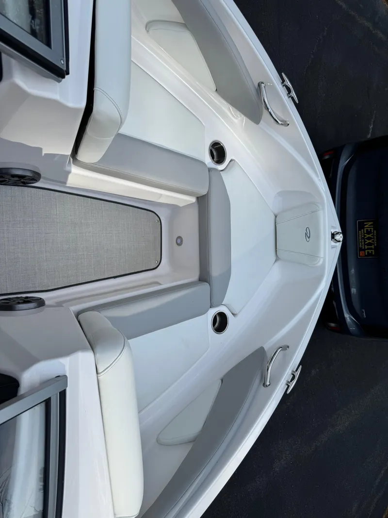Slide: The Image of 2021 Regal 1900 ES boat interior with white seating and cup holders. - 8