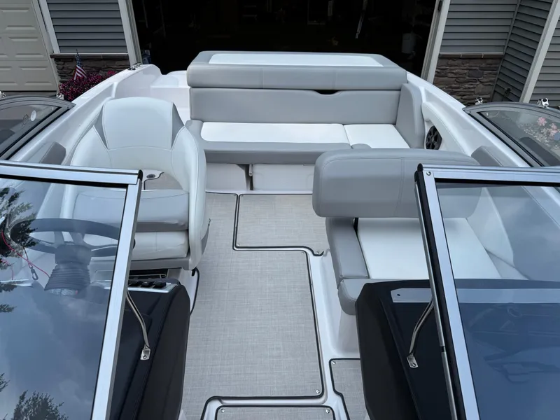 Slide: The Image of 2021 Regal 1900 ES boat interior with white and gray seating, modern design. - 9