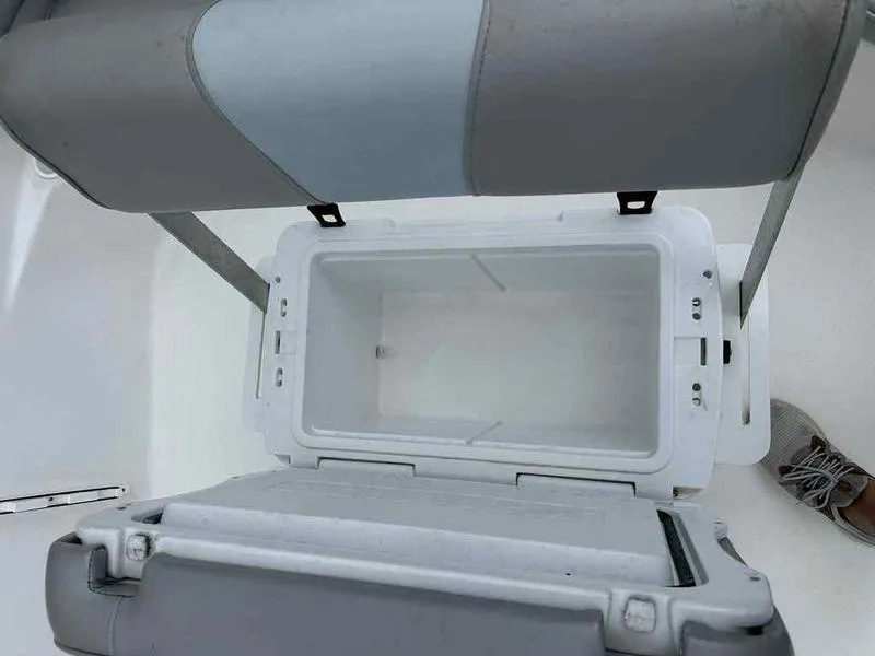 Slide: The Image of Open storage compartment on a 2022 Kenner 18 CRS boat, showing interior space. - 12