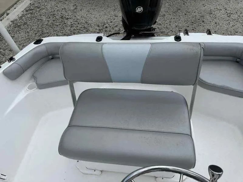 Slide: The Image of 2022 Kenner 18 CRS boat interior with gray seating and steering wheel. - 13