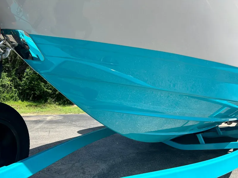 Slide: The Image of 2022 Regal LS4 Surf boat hull in vibrant blue on a trailer. - 13