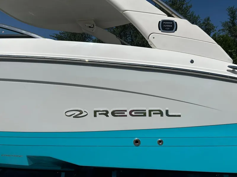 Slide: The Image of 2022 Regal LS4 Surf boat with sleek white and blue design. - 15