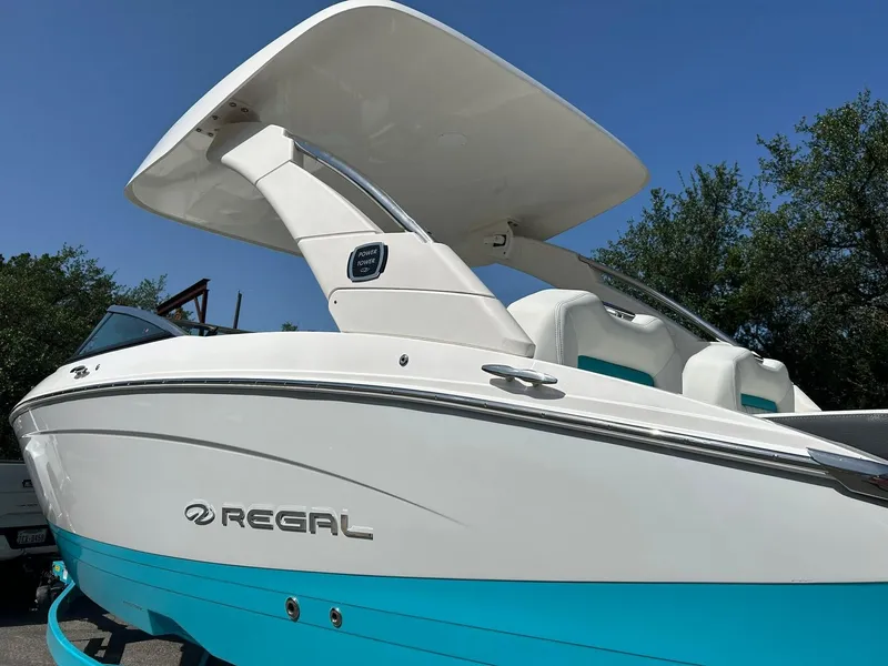 Slide: The Image of 2022 Regal LS4 Surf boat with sleek design and vibrant blue accents. - 16