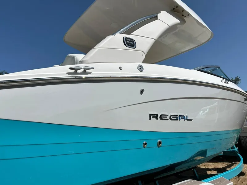 Slide: The Image of 2022 Regal LS4 Surf boat with sleek design and blue hull. - 19
