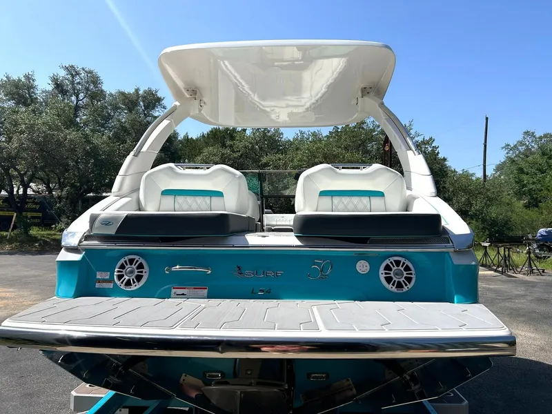 Slide: The Image of 2022 Regal LS4 Surf boat, rear view, featuring sleek design and modern amenities. - 24