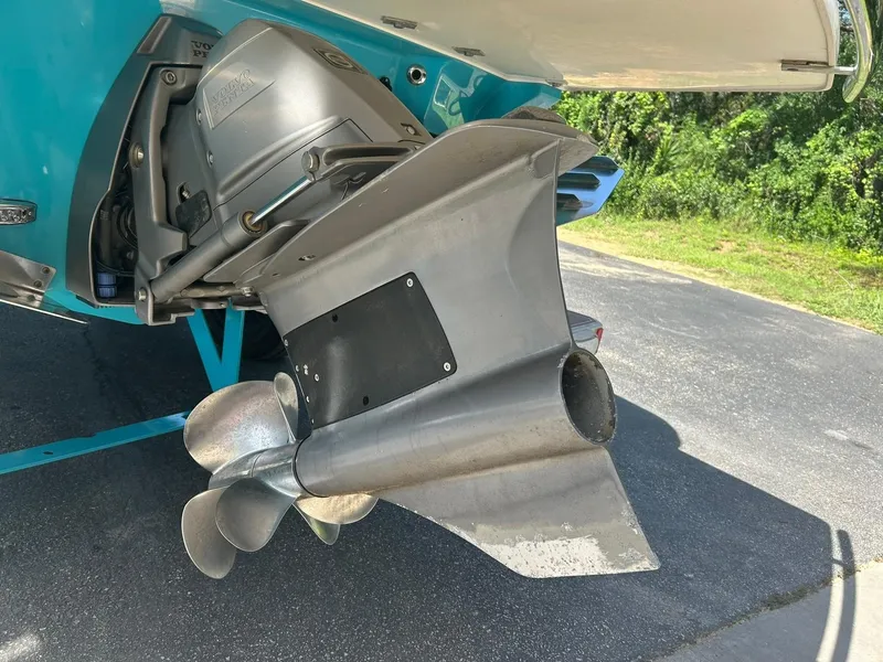 Slide: The Image of 2022 Regal LS4 Surf boat propeller and engine detail in a sunny outdoor setting. - 25