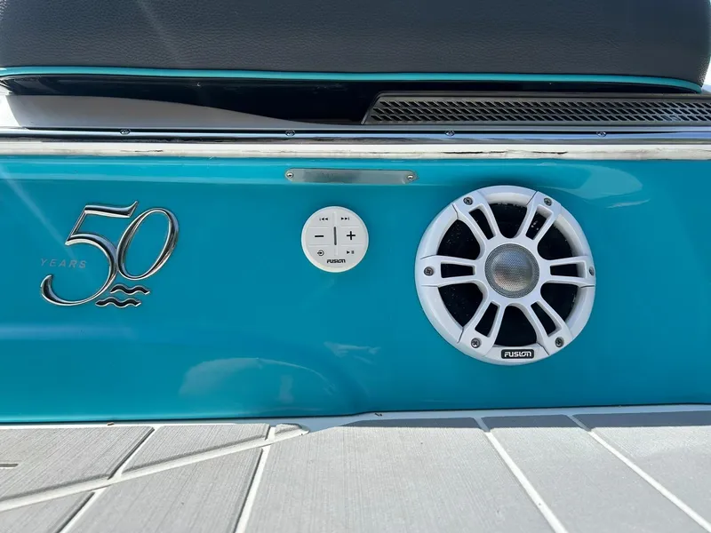 Slide: The Image of Regal LS4 Surf 2022 boat, teal exterior, Fusion speaker, 50th anniversary emblem. - 27