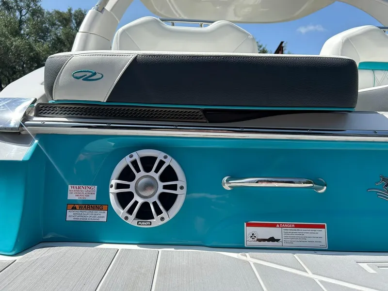 Slide: The Image of 2022 Regal LS4 Surf boat interior with speaker and warning labels, featuring sleek design elements. - 28