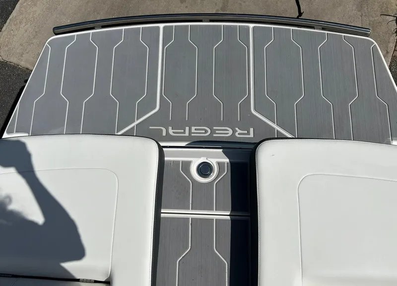 Slide: The Image of 2022 Regal LS4 Surf boat deck with sleek gray and white design. - 29