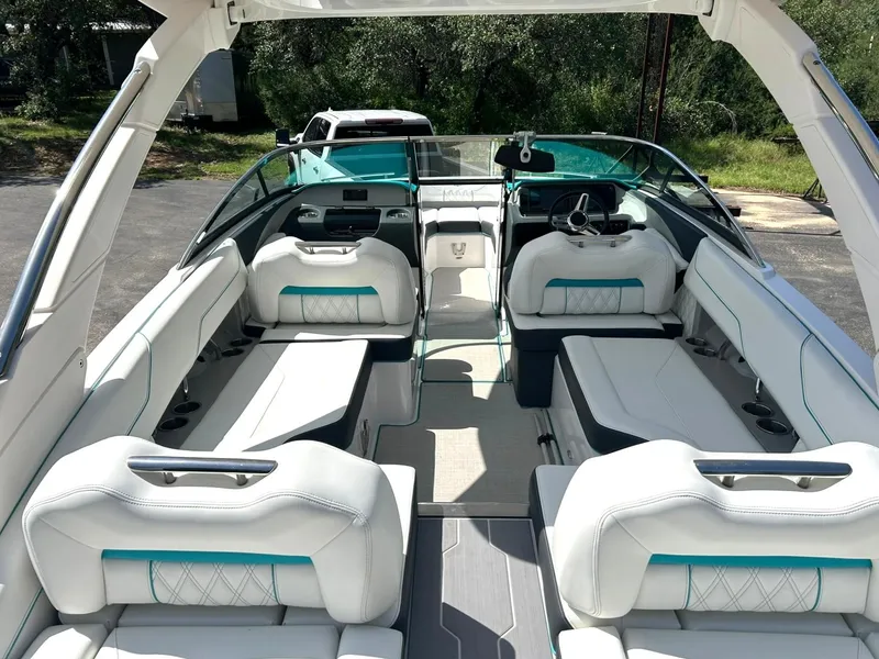 Slide: The Image of 2022 Regal LS4 Surf boat interior with white seating and modern dashboard design. - 3