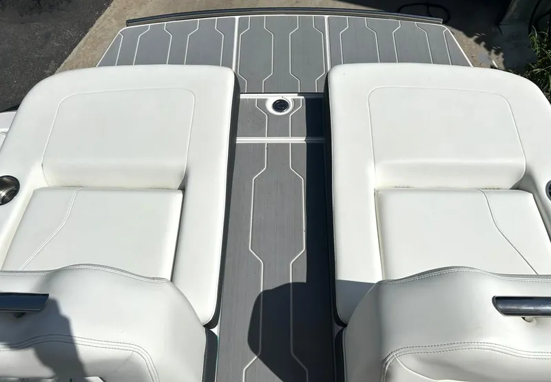 Slide: The Image of 2022 Regal LS4 Surf boat with white cushioned seats and sleek deck design. - 30