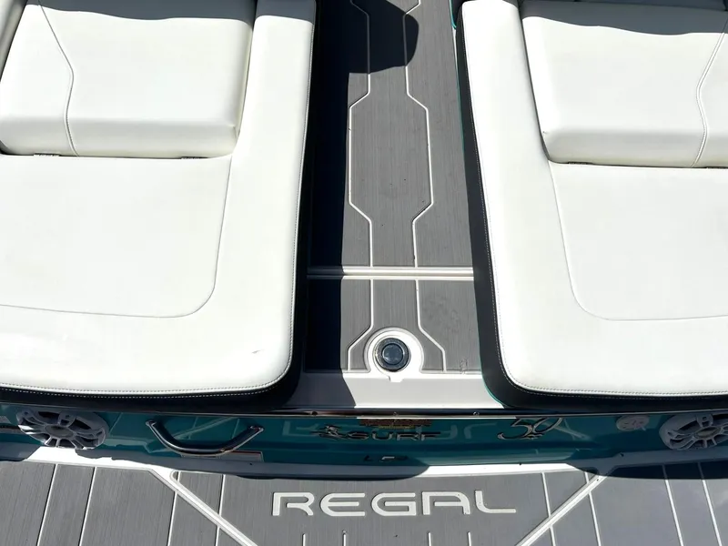 Slide: The Image of 2022 Regal LS4 Surf boat interior with white seating and sleek design. - 31