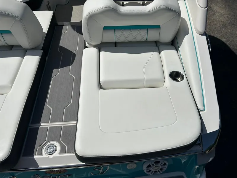 Slide: The Image of 2022 Regal LS4 Surf boat interior with white cushioned seating and cup holder. - 33