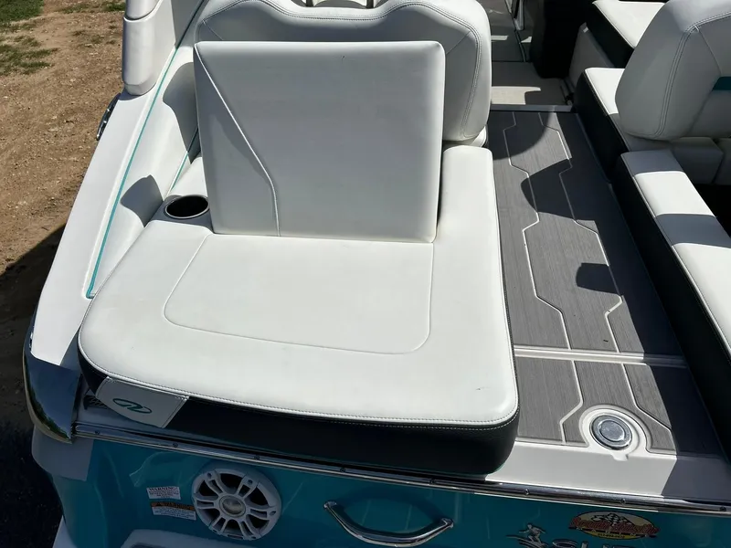 Slide: The Image of 2022 Regal LS4 Surf boat with white seating and gray deck flooring. - 34