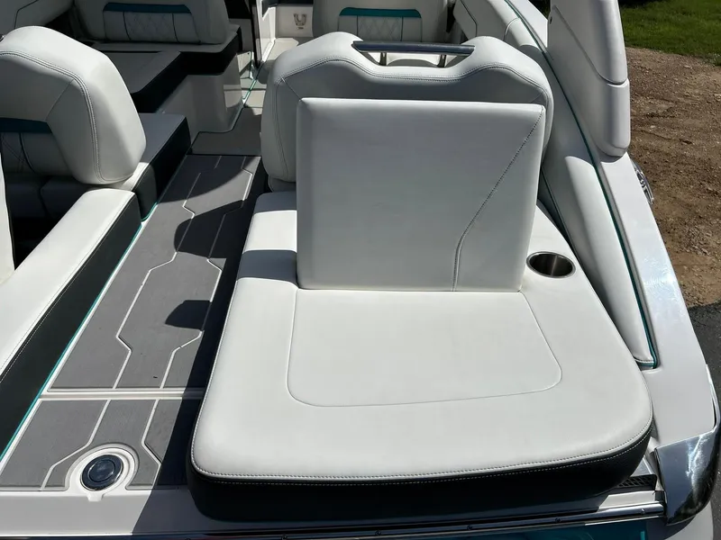 Slide: The Image of 2022 Regal LS4 Surf boat interior with white seating and cup holder. - 35