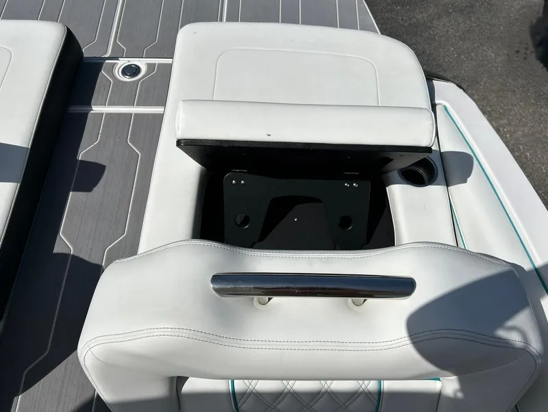 Slide: The Image of 2022 Regal LS4 Surf boat seat with storage compartment, white upholstery, and sleek design. - 36