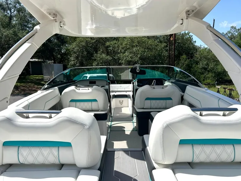 Slide: The Image of 2022 Regal LS4 Surf boat interior with white and teal seating, open-air design. - 38