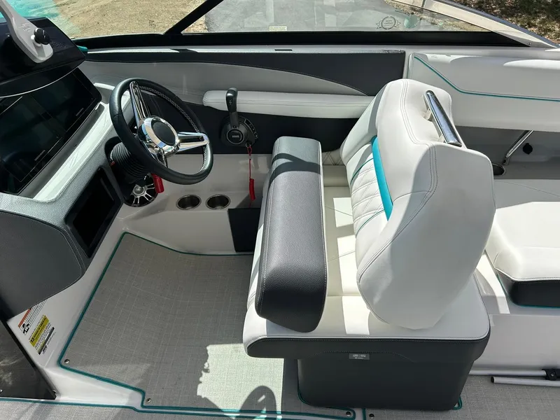 Slide: The Image of 2022 Regal LS4 Surf boat interior with steering wheel and seating. - 48