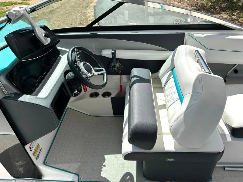 Slide: The Image of 2022 Regal LS4 Surf boat interior with modern steering and seating. - 5