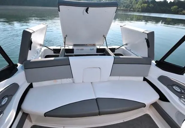 Slide: The Image of Manufacturer Provided Image: 2013 Sea Ray 205 Sport boat with open storage compartments on a calm lake. - 17