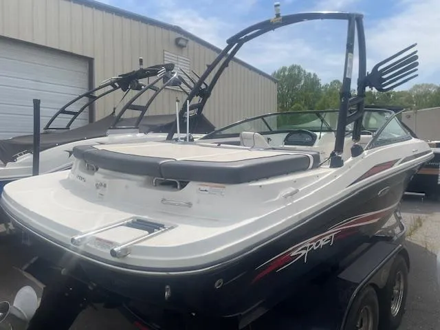 Slide: The Image of 2013 Sea Ray 205 Sport boat with wakeboard tower, parked outdoors. - 3