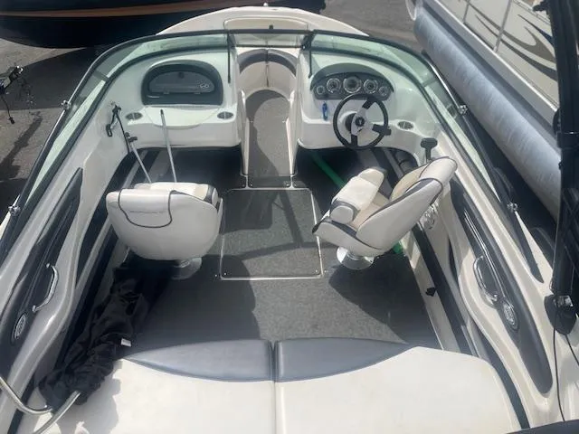 Slide: The Image of 2013 Sea Ray 205 Sport boat interior with steering wheel and seating. - 4