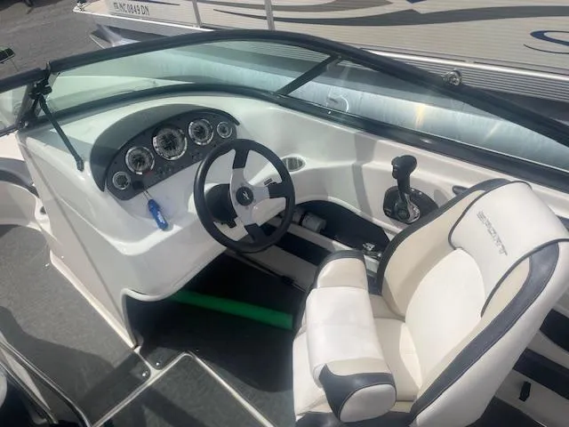 Slide: The Image of 2013 Sea Ray 205 Sport boat interior with steering wheel and control panel. - 5