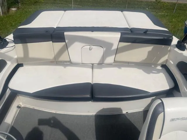 Slide: The Image of 2013 Sea Ray 205 Sport boat interior with white and black seating. - 7