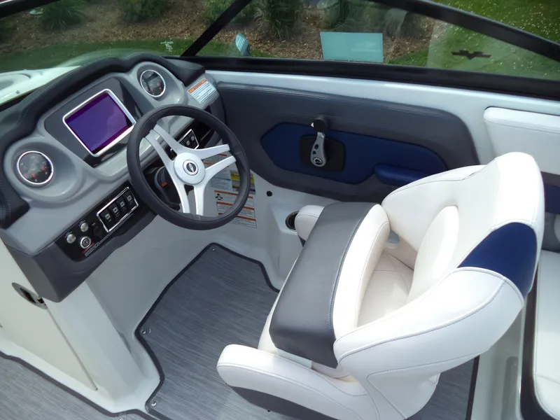 Slide: The Image of 2017 Chaparral Vortex 223 VR boat interior with steering wheel and captain's chair. - 10