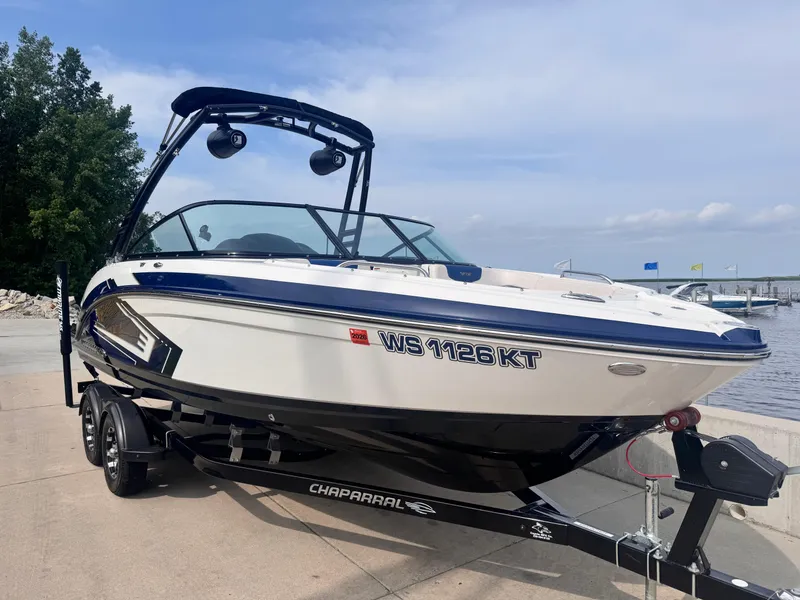 Slide: The Image of 2017 Chaparral Vortex 223 VR boat on trailer by waterfront. - 2