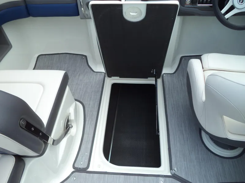 Slide: The Image of 2017 Chaparral Vortex 223 VR boat interior with open storage compartment and seating. - 22